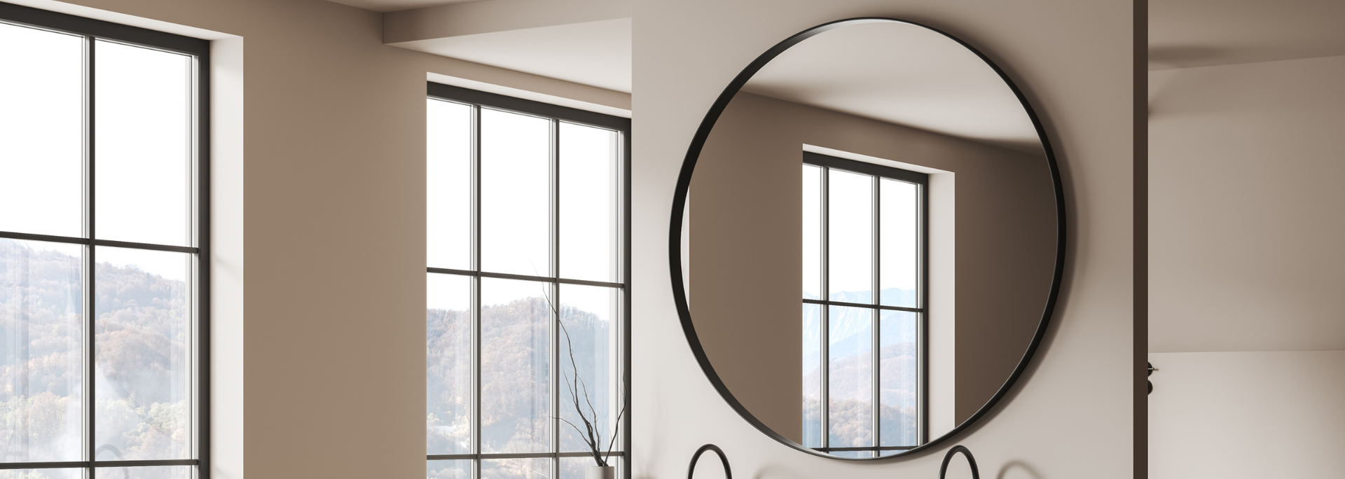 A round black-framed mirror hangs on a wall, reflecting a window. Sunlight streams in through the window.