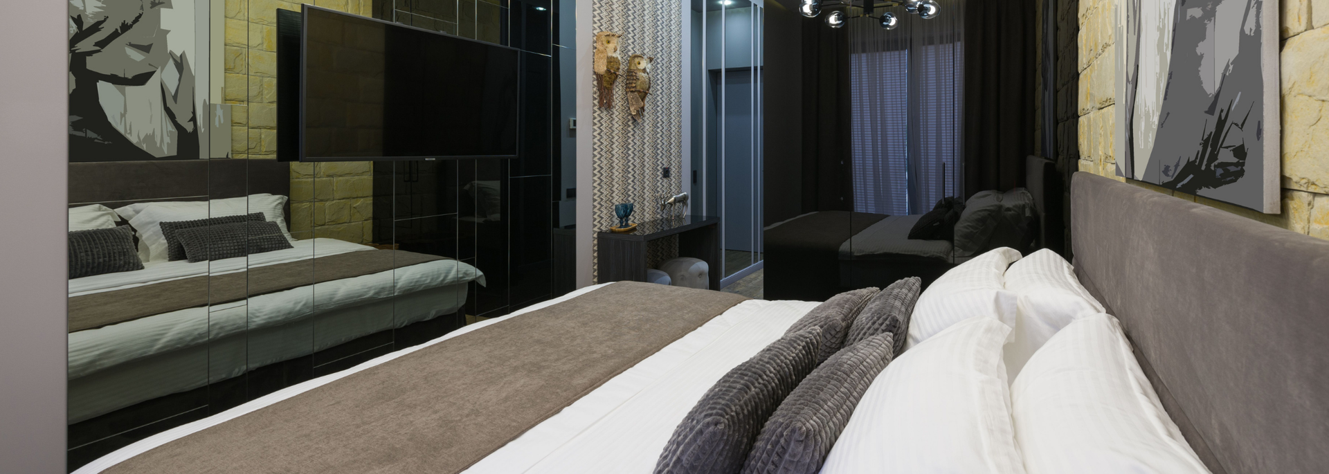 Picture of a mirror wall in a bedroom. 