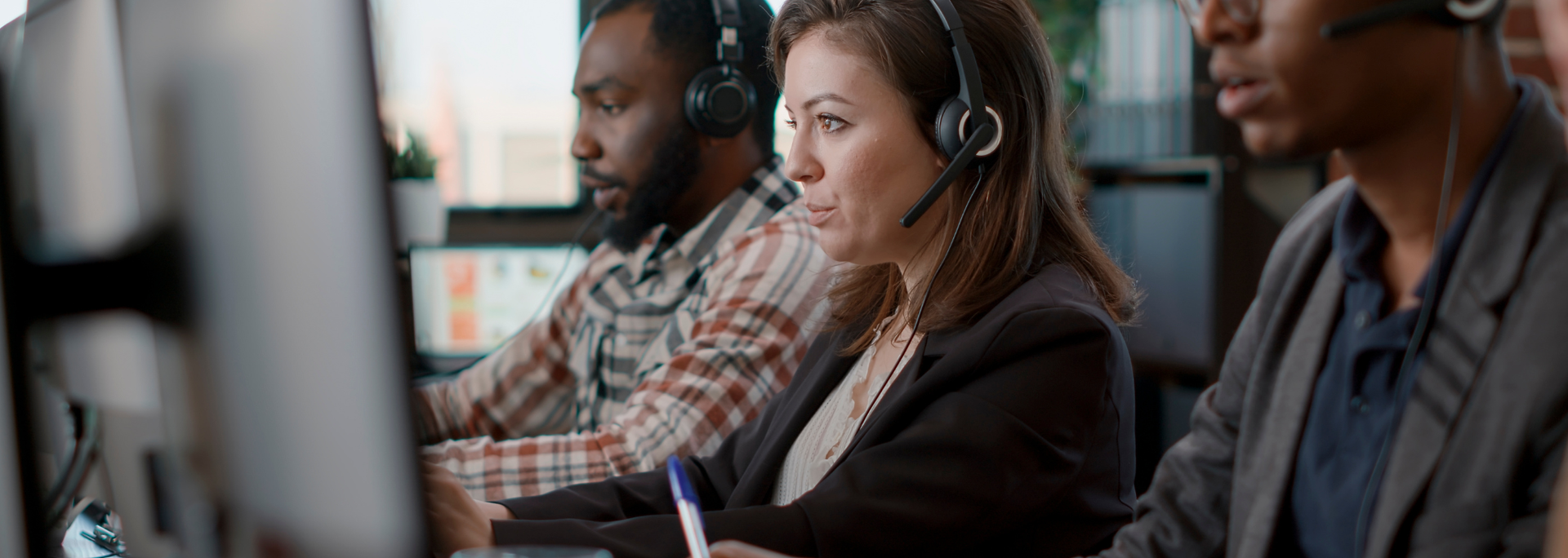 Picture of people working at a call centre. Picture of people working at a call centre.