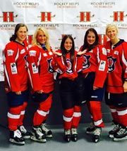 A group of women in hockey uniforms are posing for a picture.