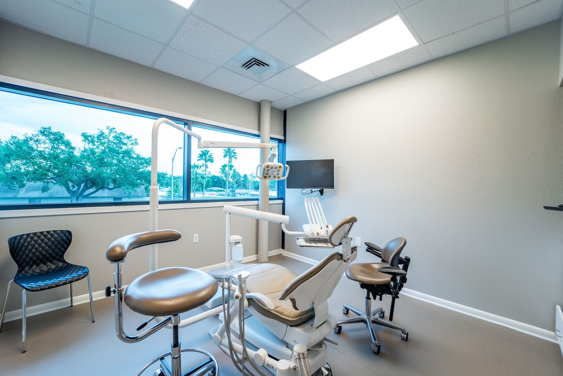 A dental office with a dental chair and chairs