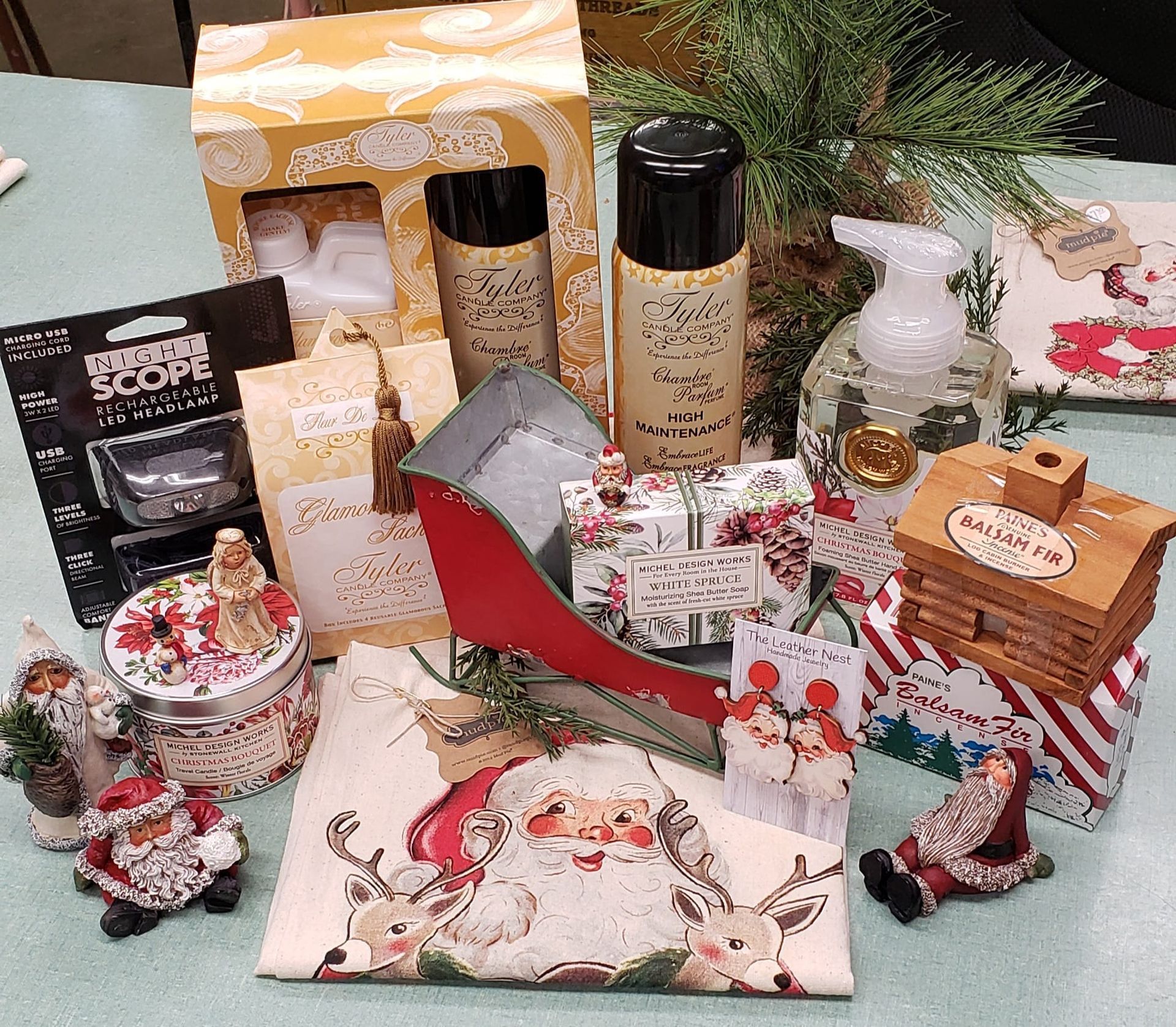 A table topped with a variety of christmas decorations and gifts.