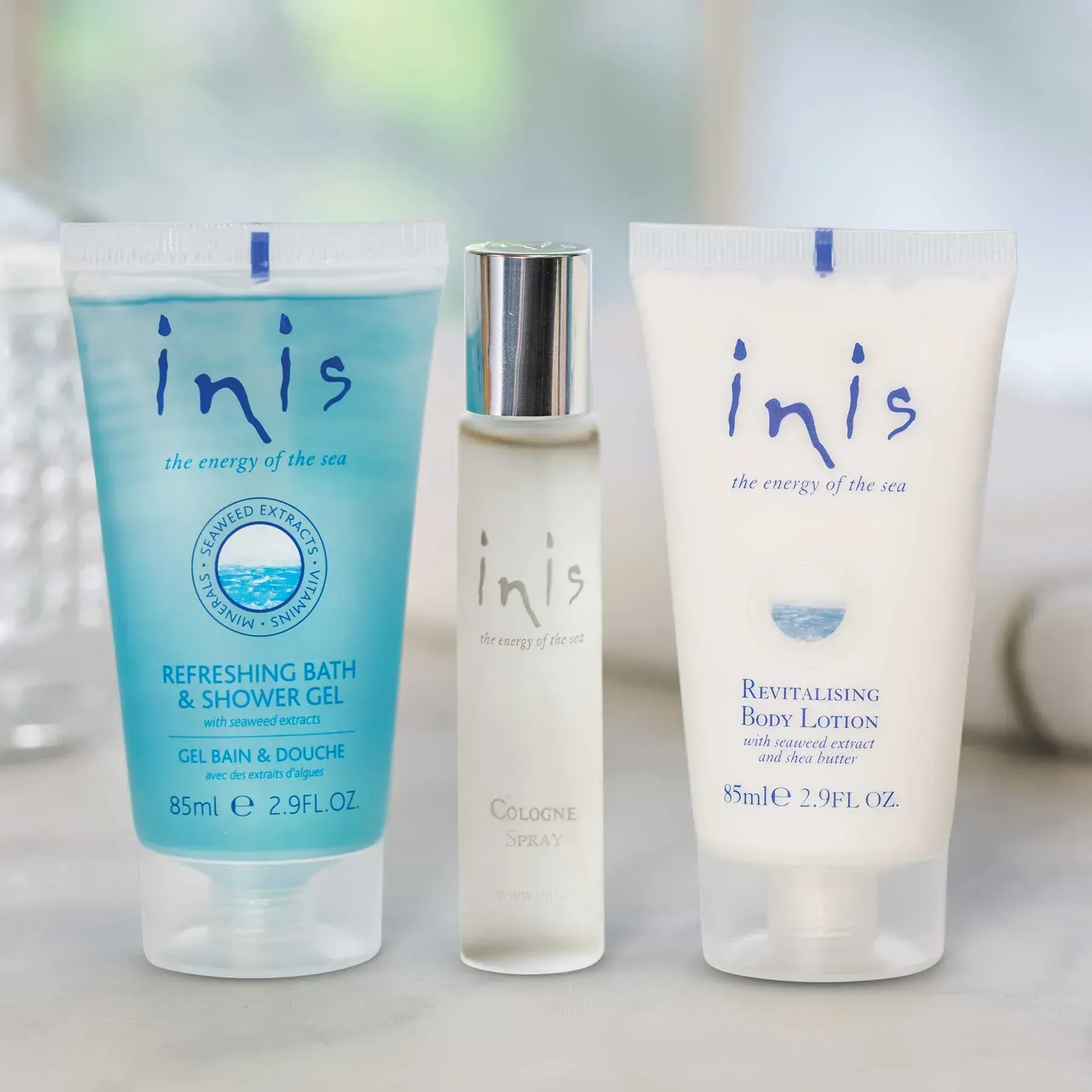 Three bottles of inis products are on a table