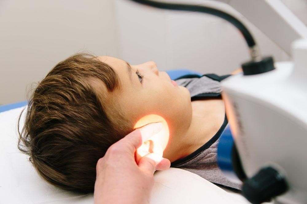 Audiologist performing safe microsuction ear wax removal in Ealing clinic.