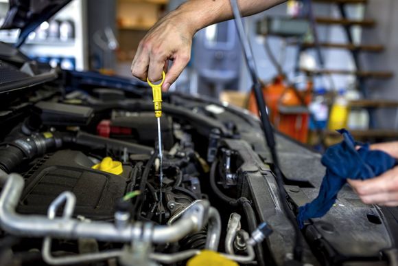 Man Checking Engine Fuel — Waxahachie, TX — Walton’s Total Car Care Man Checking Engine Fuel — Waxahachie, TX — Walton’s Total Car Care
