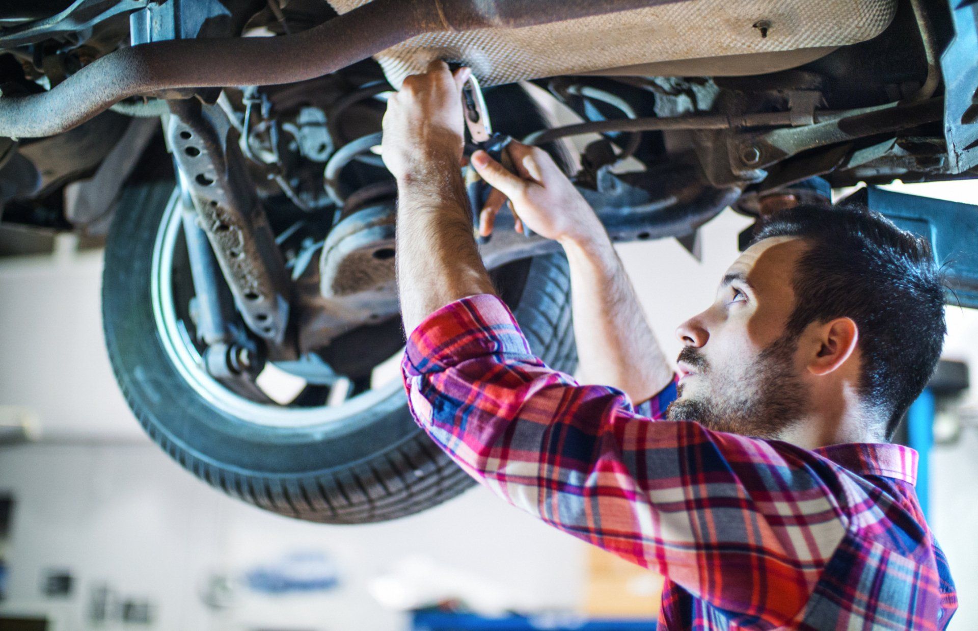 Man Repairing Car Brakes — Waxahachie, TX — Walton’s Total Car Care Man Repairing Car Brakes — Waxahachie, TX — Walton’s Total Car Care