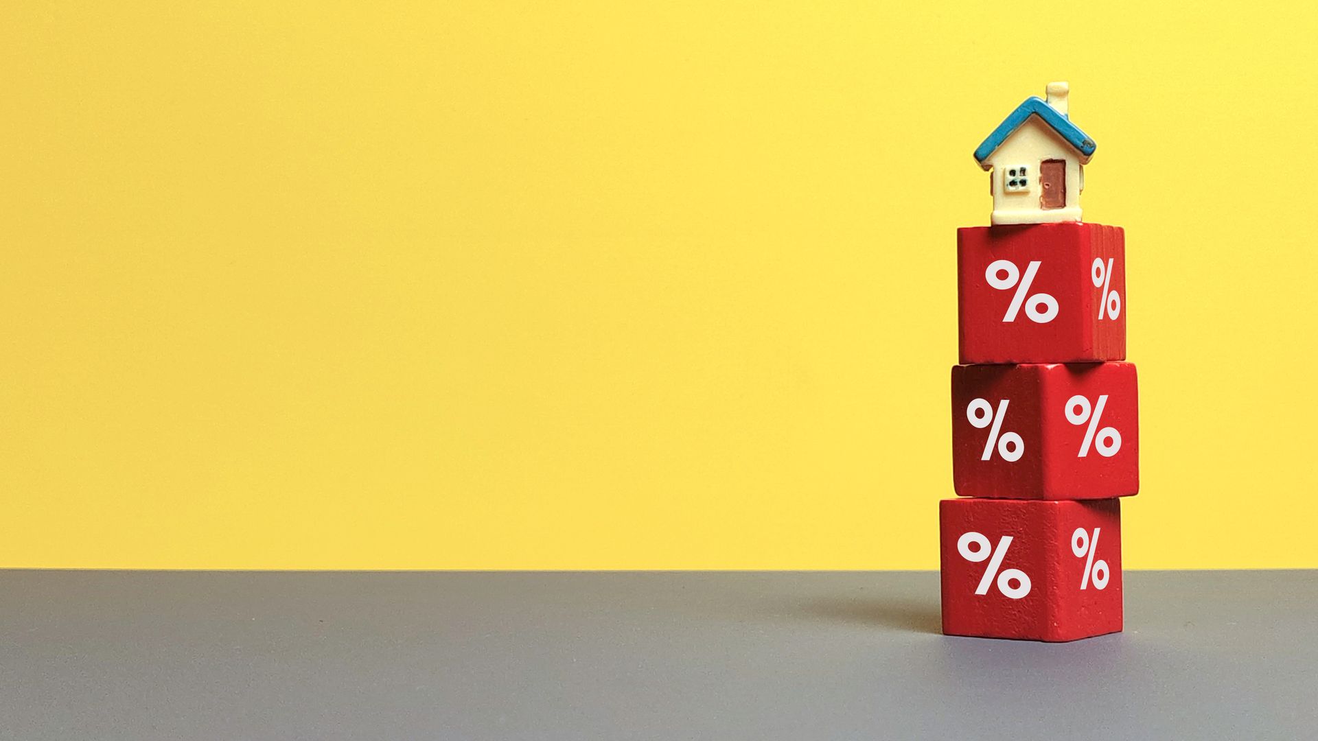 Stacked percentage blocks with a small house on top against a bright yellow background.