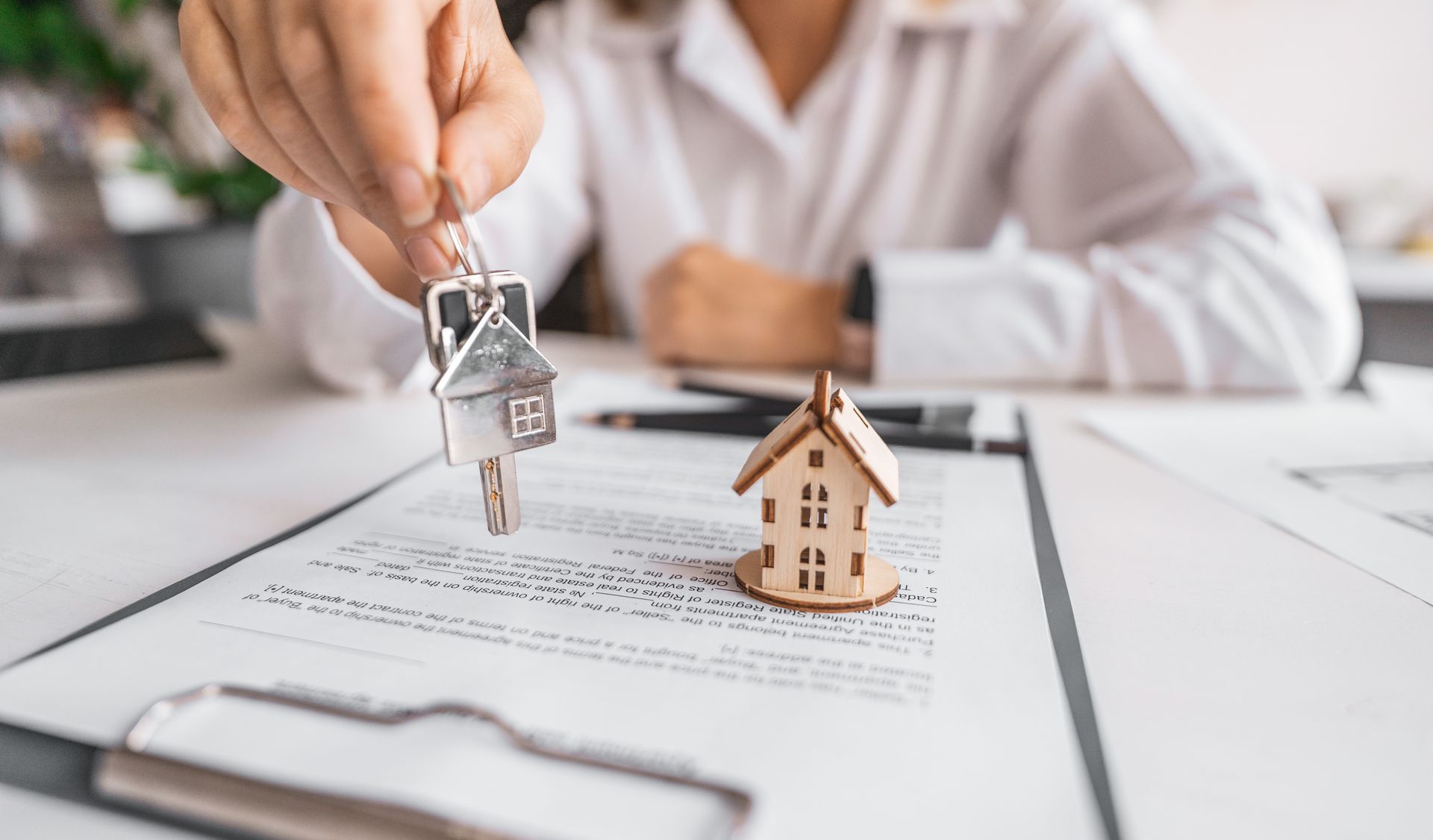 Mortgage broker over house key depiction of loan process