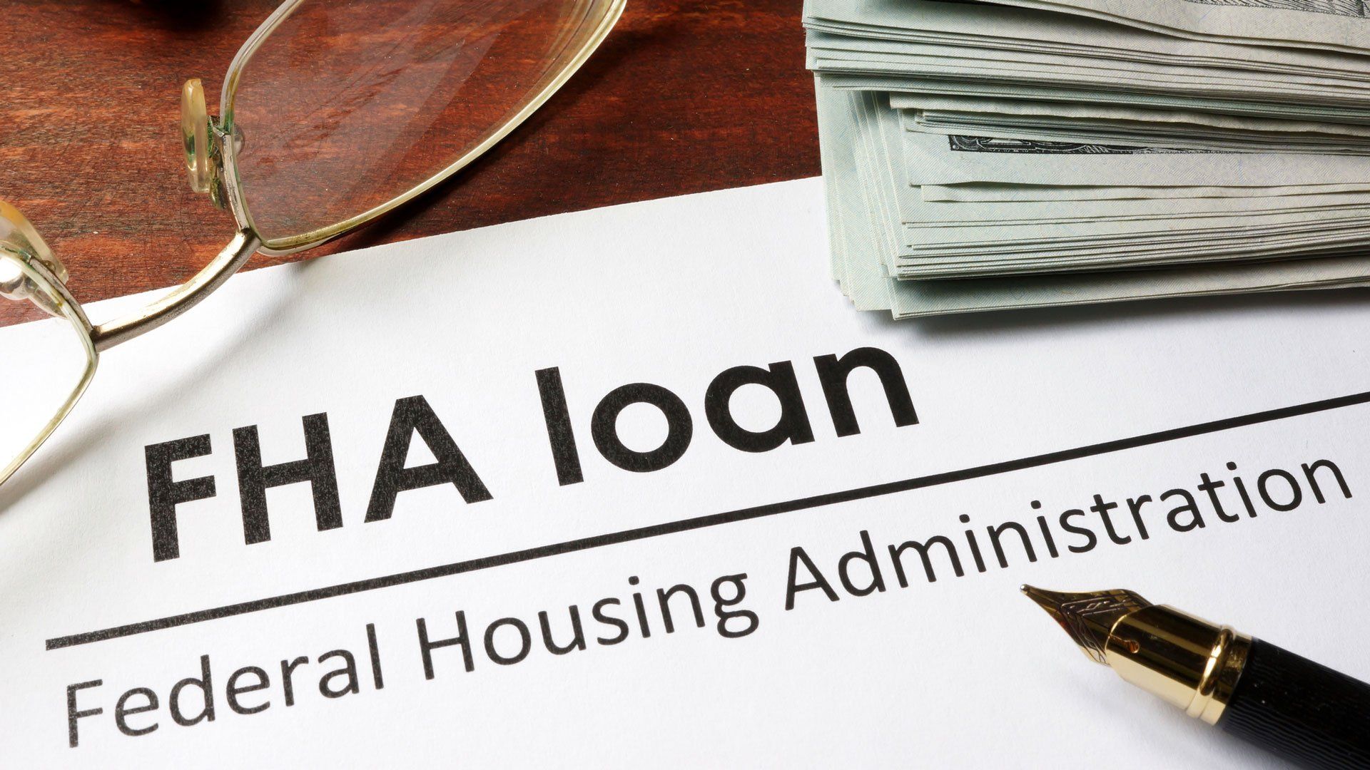FHA loan document with glasses and pen on a desk, showing Federal Housing Administration text