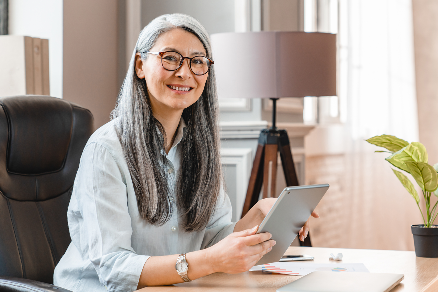 executive woman sitting at desk in need of executive coaching