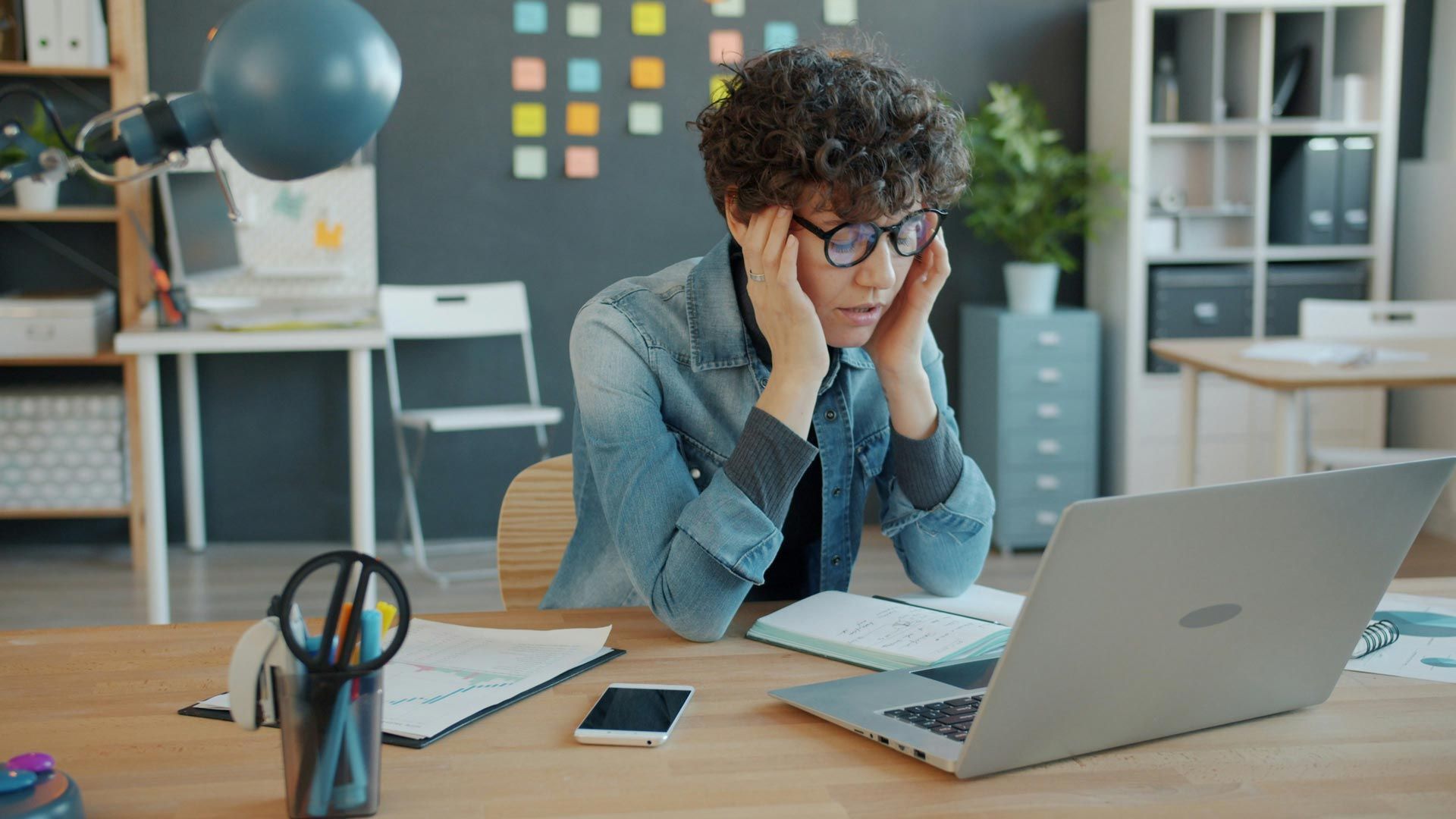Frustrated job seeker reviewing automated job applications submitted by artificial intelligence