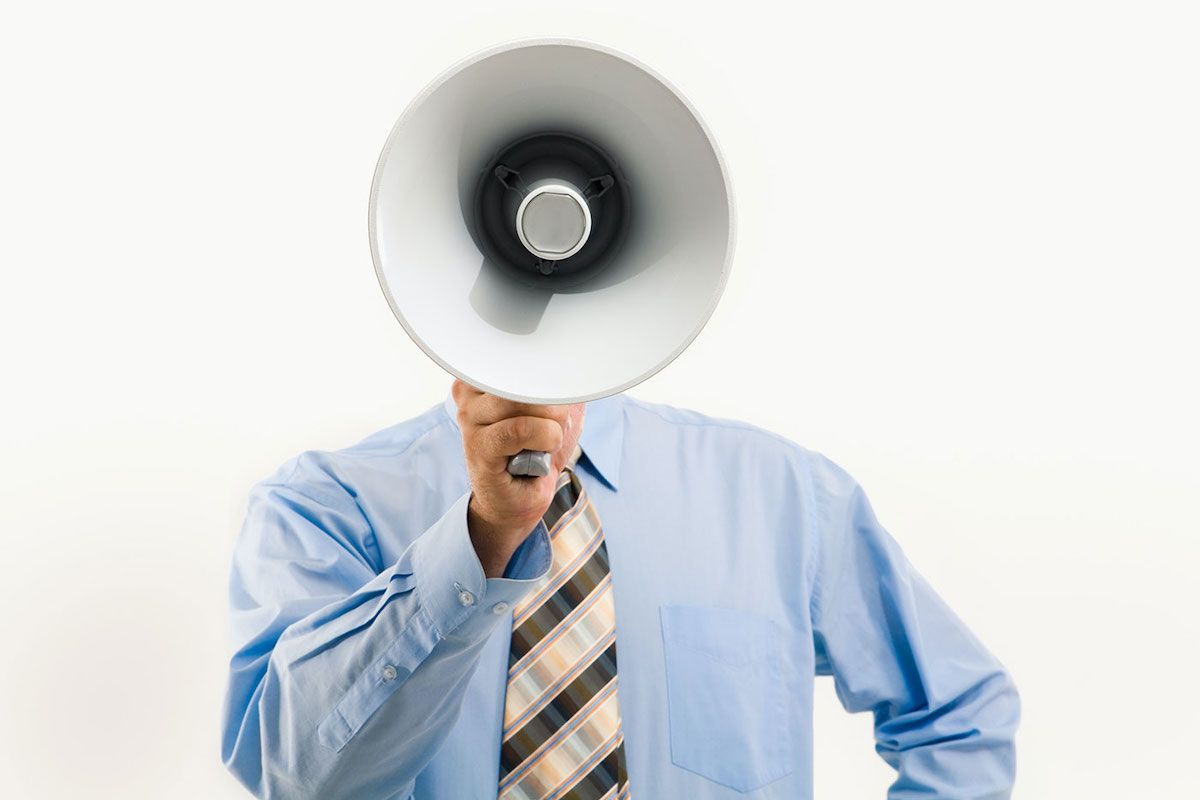 Professional holding megaphone representing the decision to change jobs & start a career transition