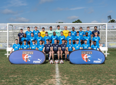 SCUFC's USL 2 Men's Bantam soccer players are posing for a team photo.