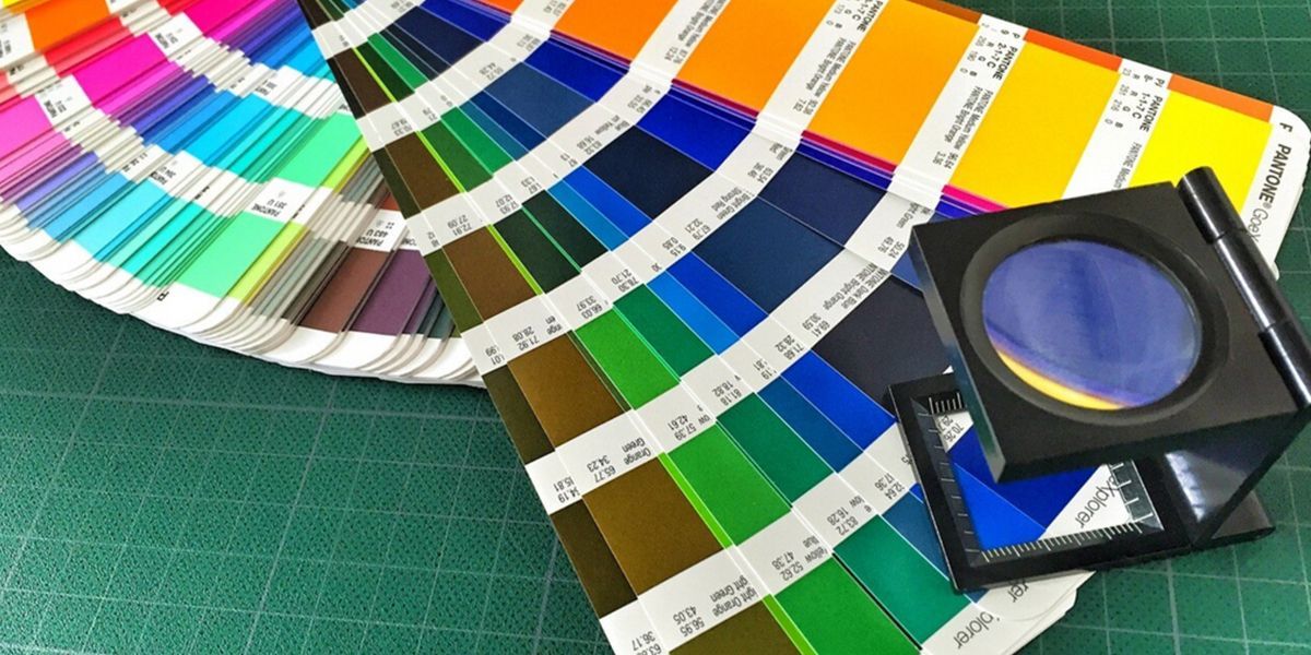 Color swatches with a magnifying glass on a green cutting mat.