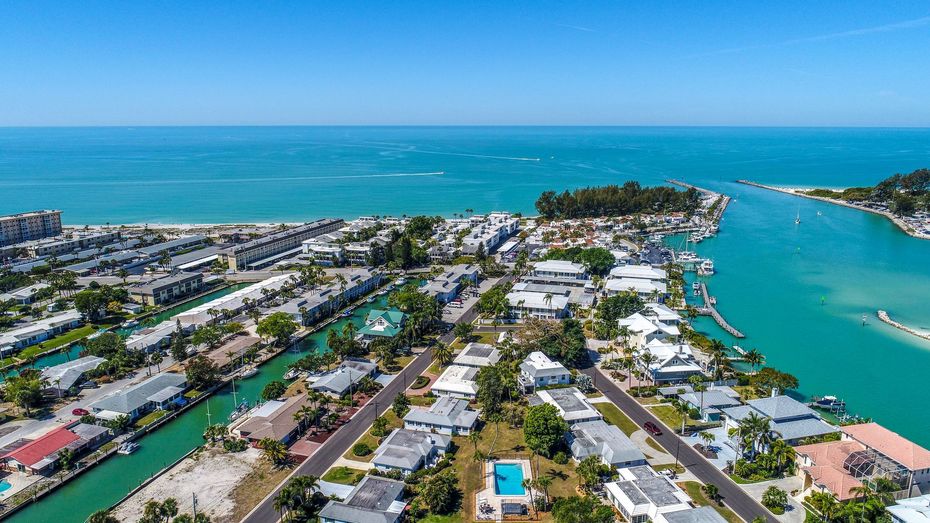 An aerial view of a residential area next to a body of water.