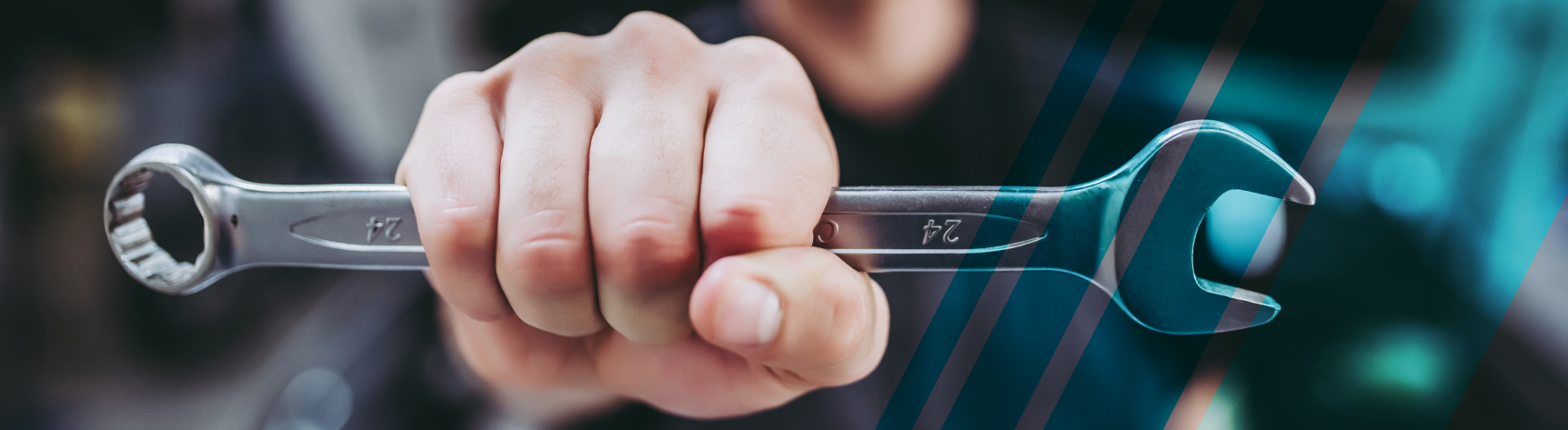 Up close to a man's fist holding a wrench | Felix Auto Service