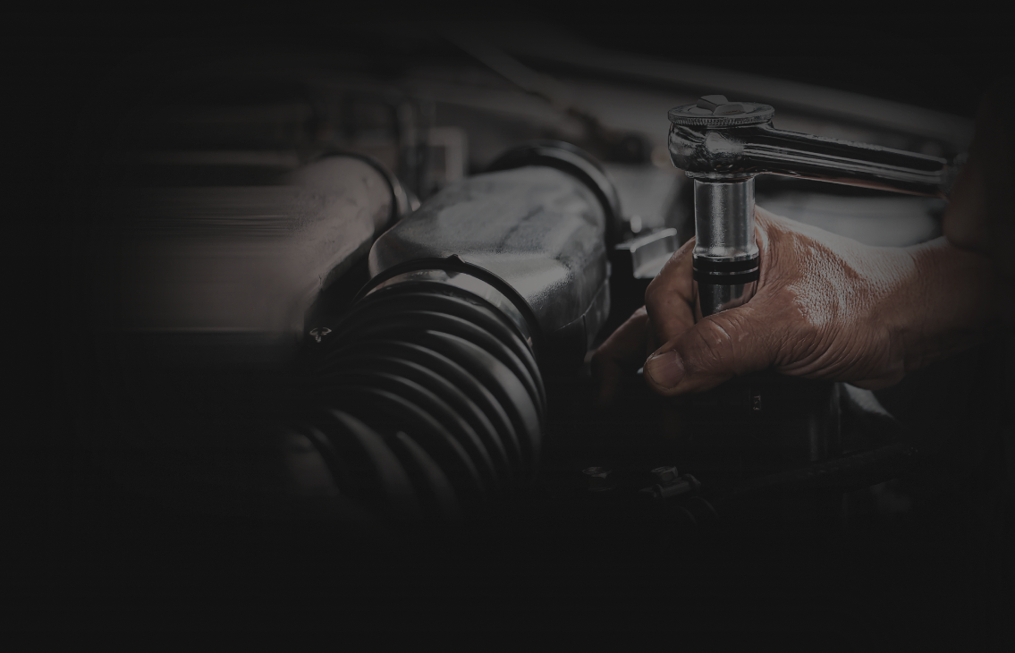Technician working on vehicle with rachet | Felix Auto Service