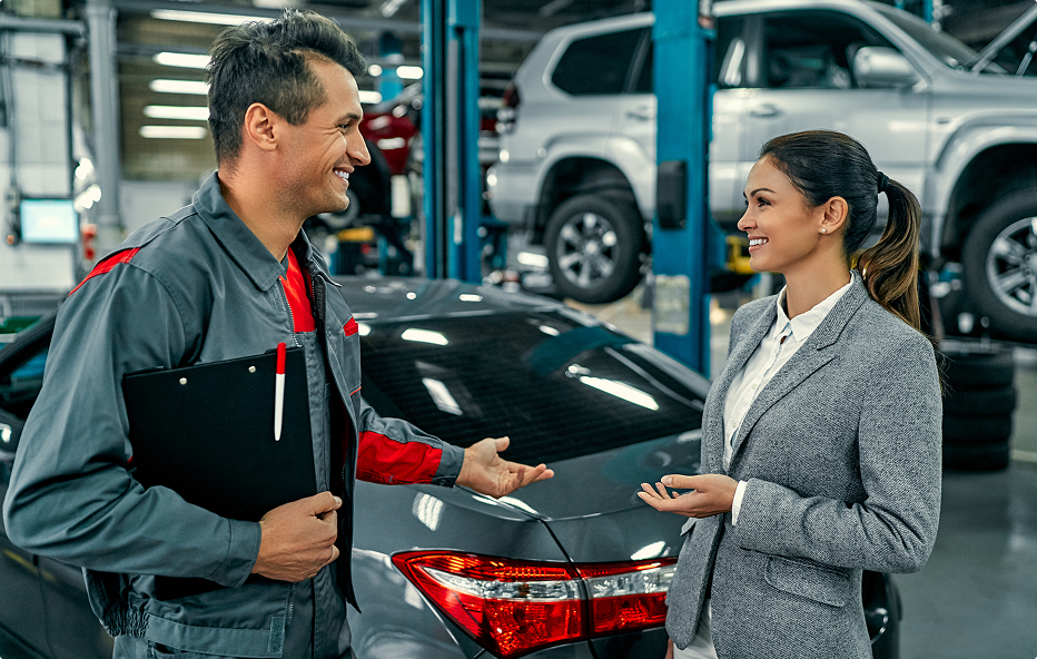 Technician discussing with customer about vehicle in garage | Felix Auto Service
