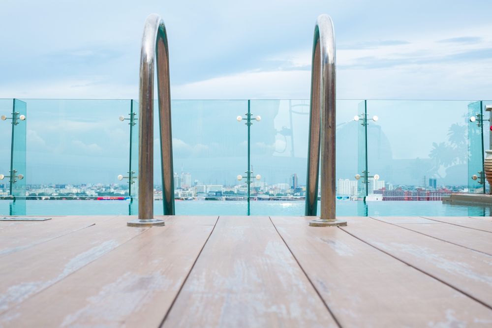 Pool with Chrome Ladder, Glass Railing, and Cityscape Backdrop — Sunshine Gates in Noosa, QLD