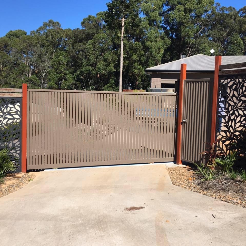 A Fence With a Sliding Gate in Front of a House — Sunshine Gates in Kunda Park, QLD