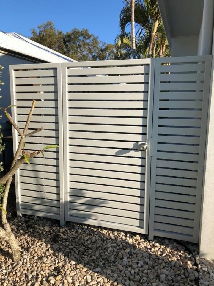 A White Fence With a Gate in Front of a House — Sunshine Gates in Kunda Park, QLD