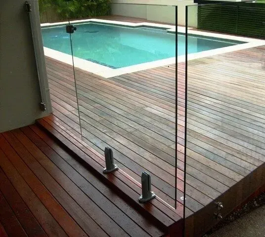 A Swimming Pool is Behind a Glass Fence on a Wooden Deck — Sunshine Gates in Mooloolaba, QLD