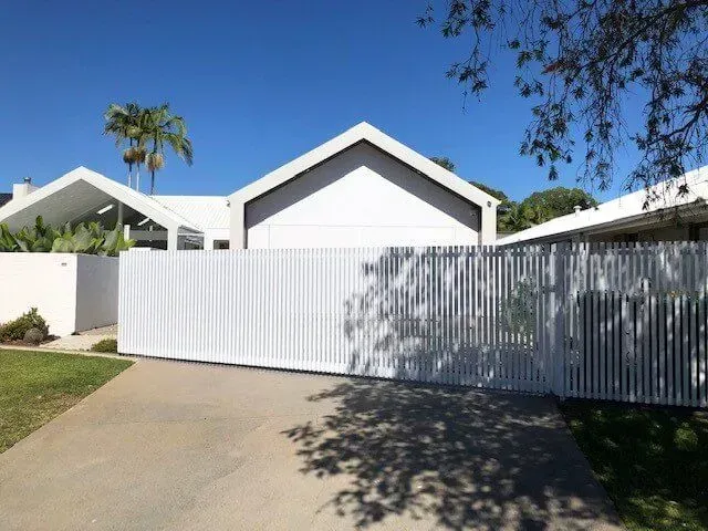 A White House With a Sliding Gate in Front of It — Sunshine Gates in Kunda Park, QLD