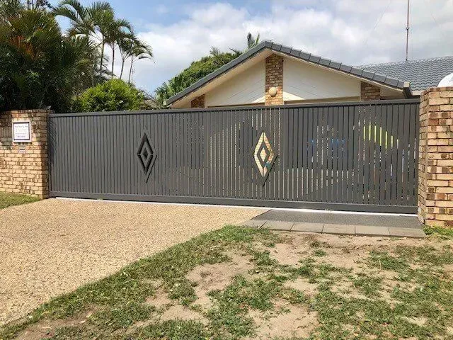 A House With a Sliding Gate in Front of It — Sunshine Gates in Kunda Park, QLD