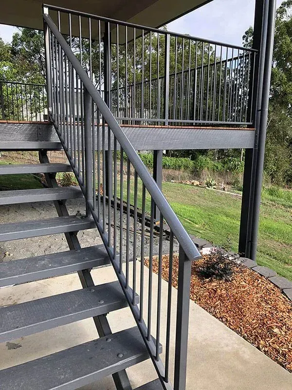 A Set of Stairs With a Metal Railing Leading Up to a Balcony — Sunshine Gates in Kunda Park, QLD