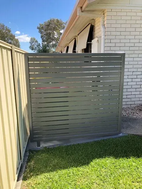 A House With a Fence and a Lawn in Front of It — Sunshine Gates in Kunda Park, QLD
