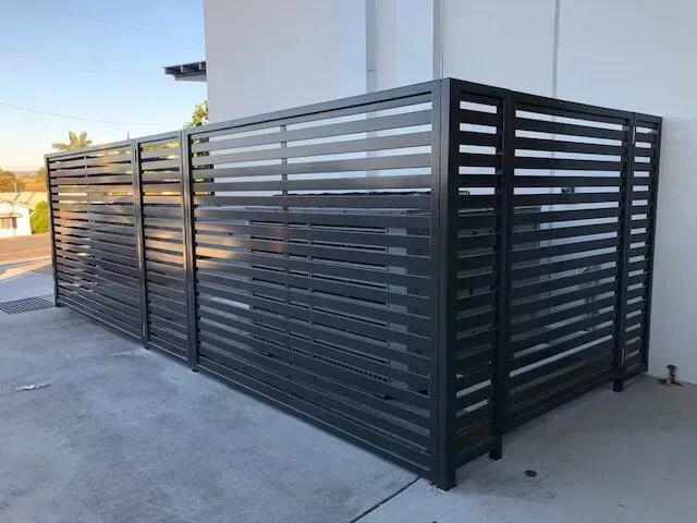 A Black Metal Fence is Sitting on the Side of a Building — Sunshine Gates in Kunda Park, QLD