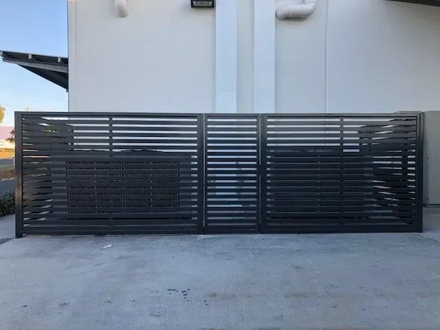 A Black Fence is Sitting in Front of a White Building — Sunshine Gates in Kunda Park, QLD