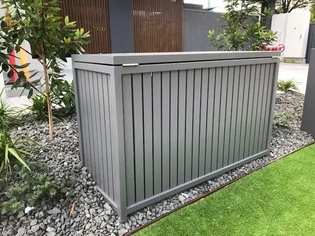 A Gray Wooden Box is Sitting on Top of a Lush Green Lawn — Sunshine Gates in Kunda Park, QLD