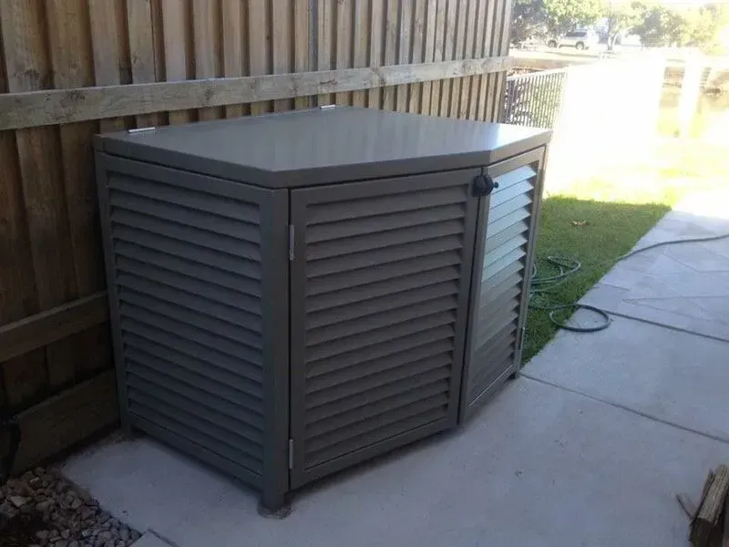 A Gray Metal Box With Shutters on the Doors is Sitting on a Sidewalk — Sunshine Gates in Kunda Park, QLD