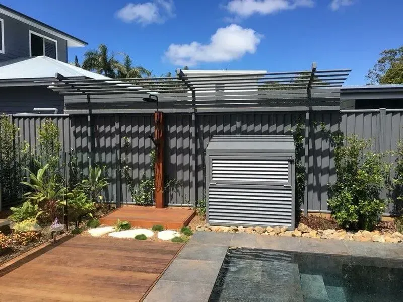 A House With a Fence and a Pool in Front of It — Sunshine Gates in Kunda Park, QLD