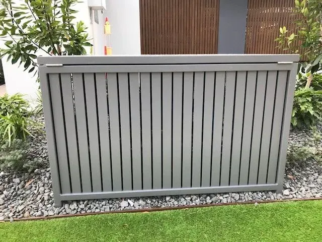 A Gray Fence is Sitting on Top of a Lush Green Lawn in Front of a House — Sunshine Gates in Kunda Park, QLD