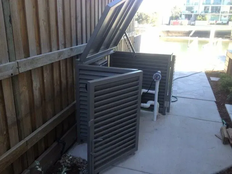 A Metal Box With the Lid Open is Sitting on a Sidewalk Next to a Wooden Fence — Sunshine Gates in Kunda Park, QLD
