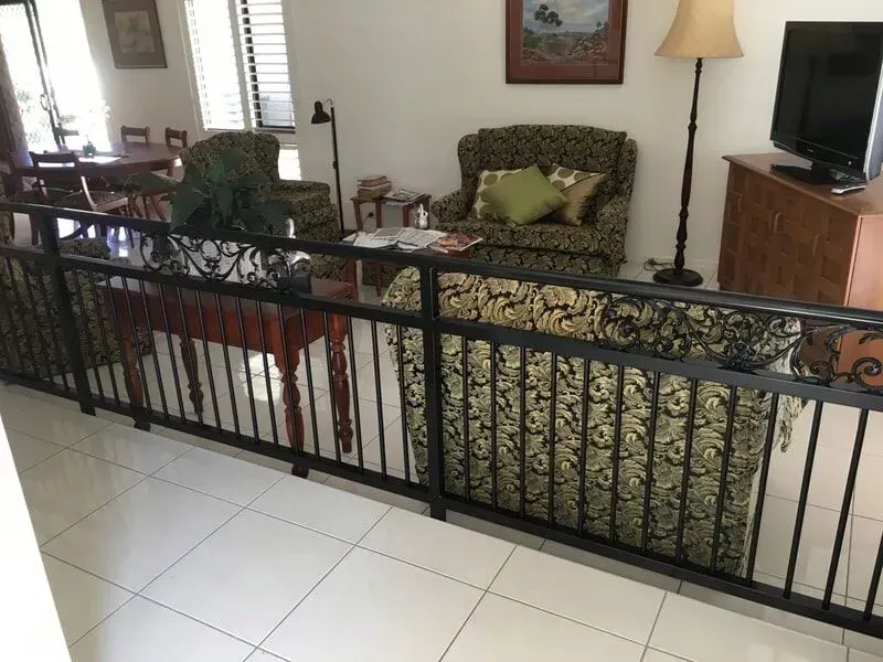 A Living Room With a Couch a Chair and a Television — Sunshine Gates in Kunda Park, QLD