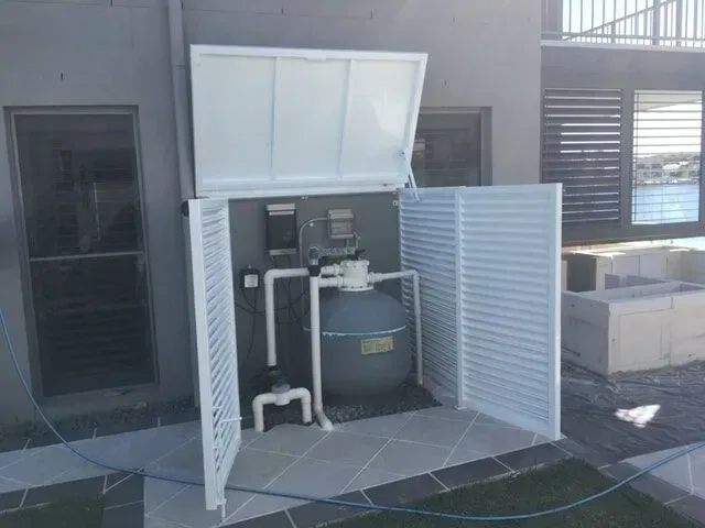 A Swimming Pool Filter is Sitting Inside of a White Box — Sunshine Gates in Kunda Park, QLD