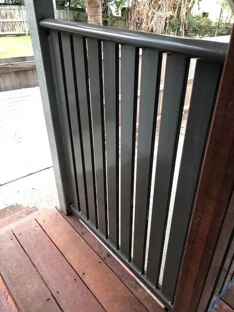 A Close Up of a Black Railing on a Wooden Deck — Sunshine Gates in Kunda Park, QLD