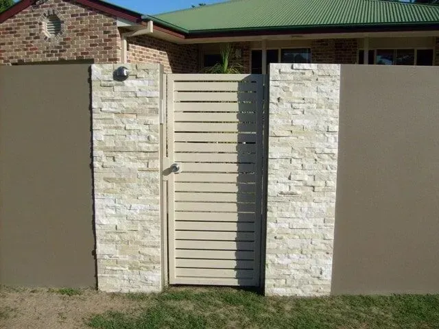 A Fence With a Gate in Front of a House — Sunshine Gates in Kunda Park, QLD