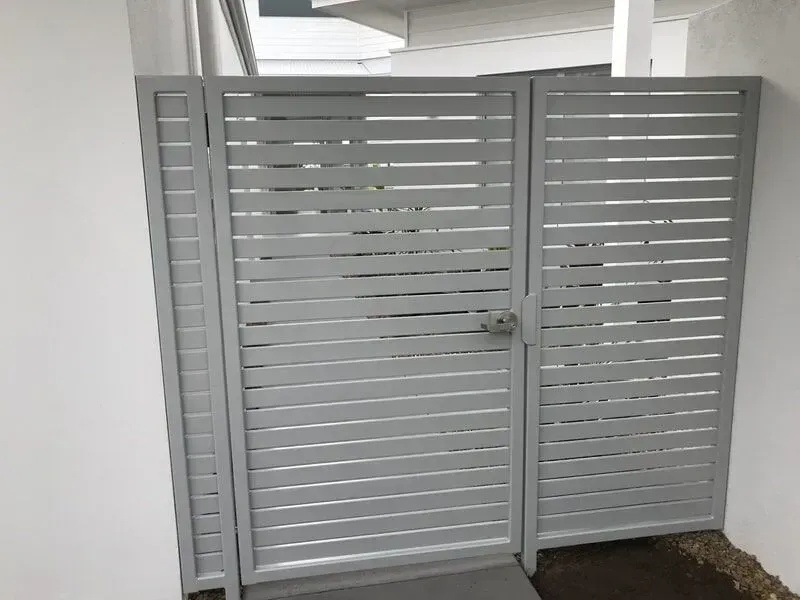 A White Gate is Sitting Next to a White Wall — Sunshine Gates in Kunda Park, QLD