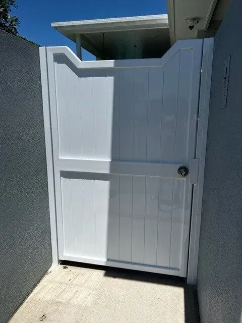 A White Gate is Sitting on the Side of a Building — Sunshine Gates in Kunda Park, QLD