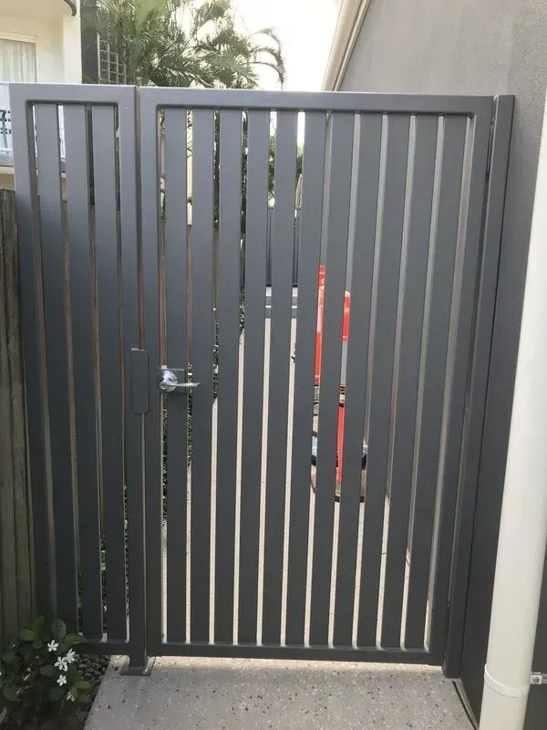 A Gray Metal Gate With a White Handle — Sunshine Gates in Kunda Park, QLD