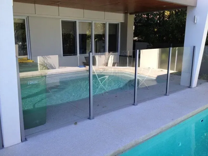 Glass pool fence around a backyard swimming pool — Sunshine Gates in Caloundra, QLD