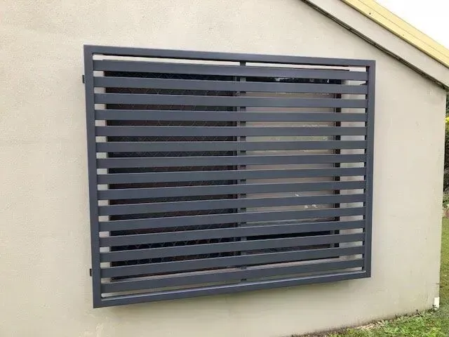 A wIndow With a Fence Around It is on the Side of a Building — Sunshine Gates in Kunda Park, QLD