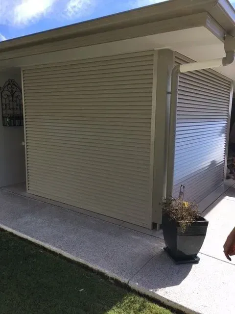 A White House With a Potted Plant in Front of It — Sunshine Gates in Kunda Park, QLD