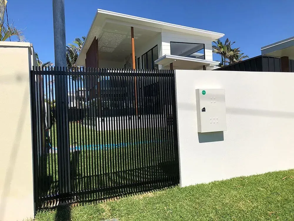 A White House With a Black Fence and a Mailbox in Front of It — Sunshine Gates in Kunda Park, QLD