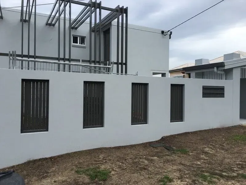 A White Building With a Fence Around It and a Lot of Windows — Sunshine Gates in Kunda Park, QLD