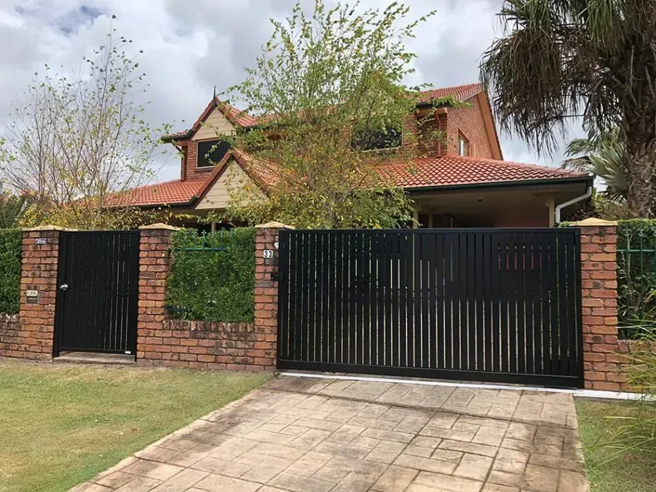 A Large House With a Black Gate in Front of It— Sunshine Gates in Kunda Park, QLD